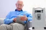 person using Evox oxygen concentrator